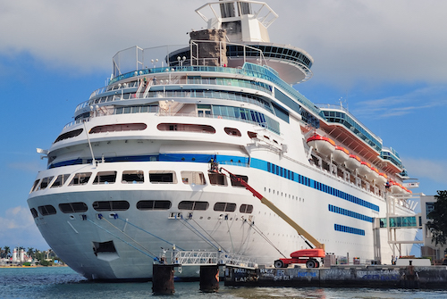 Cruise ship park at Miami dock with cloud and blue sky.