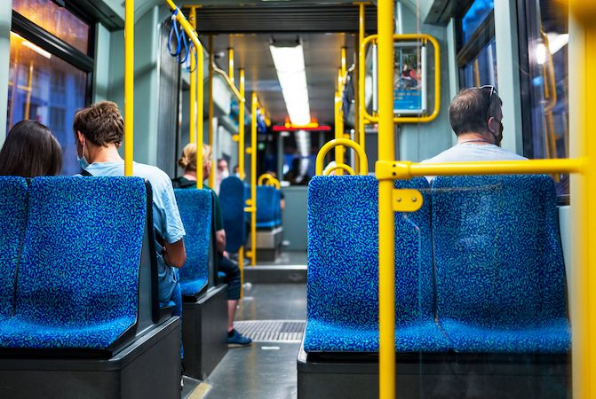 View of the interior of a tram in Frankfurt, Germany. A few sitting people